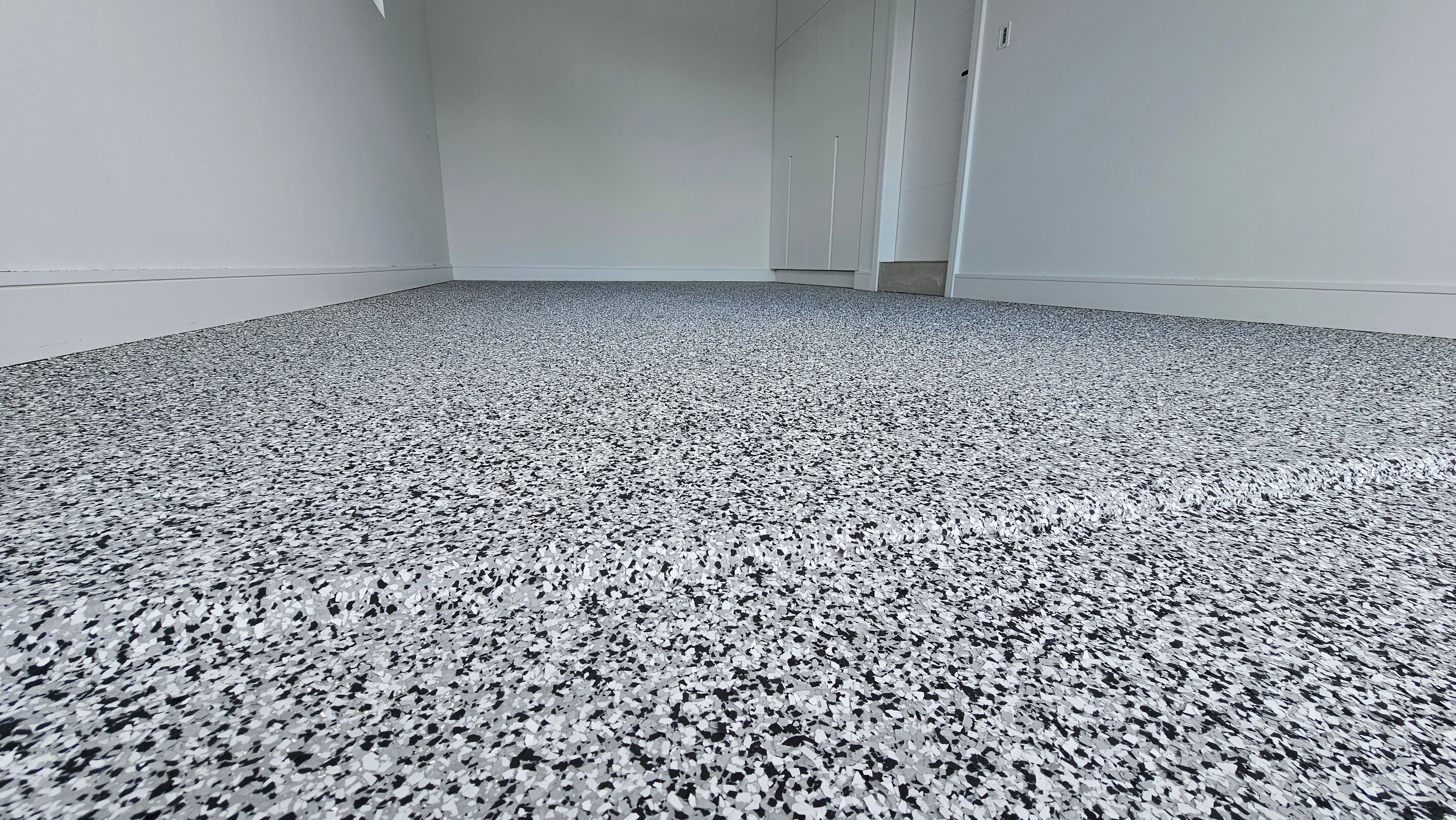 Black and white flake epoxy floor in residential room