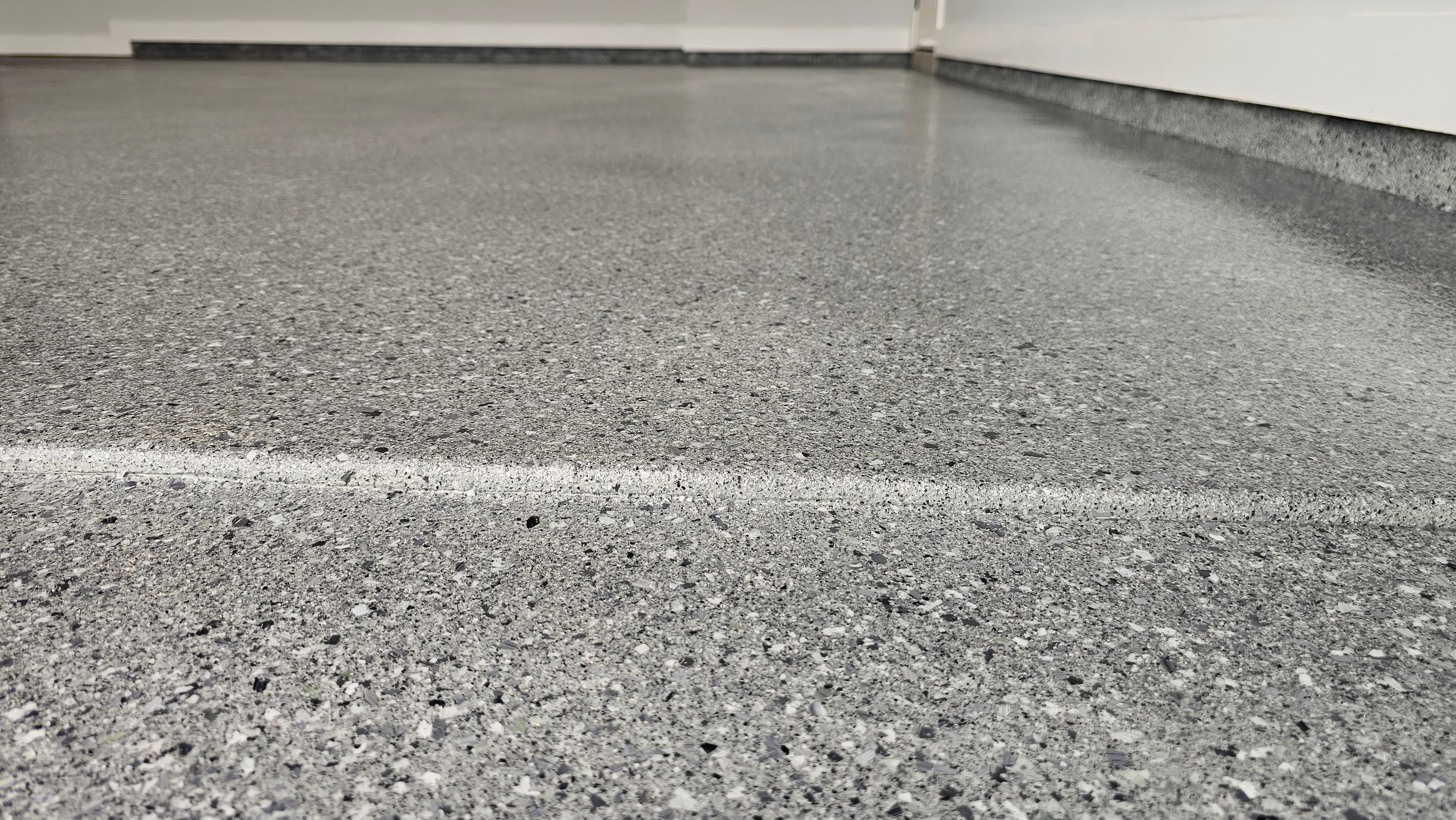 Grey flake epoxy floor close-up corner view