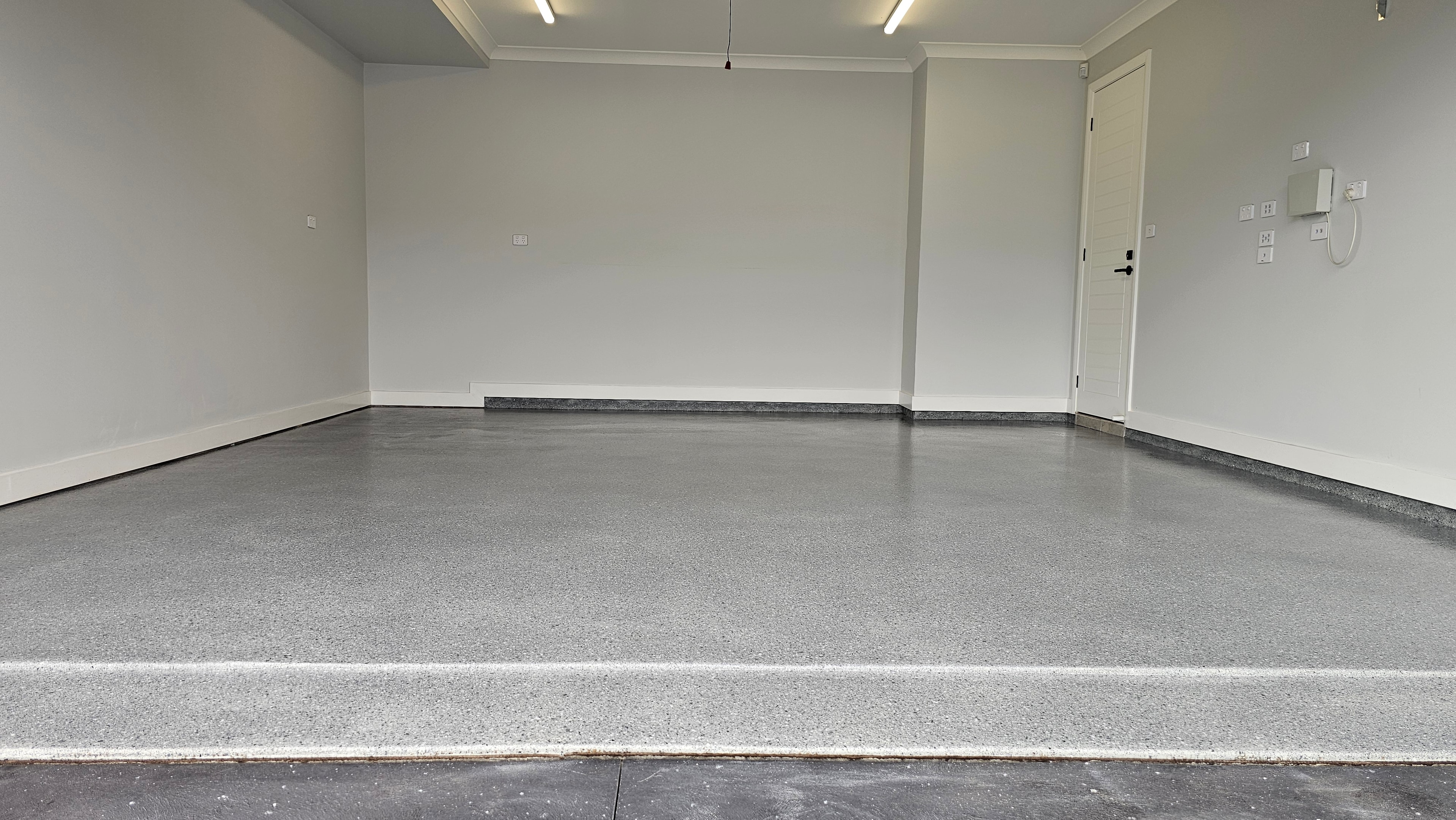 Completed grey flake epoxy garage floor full view