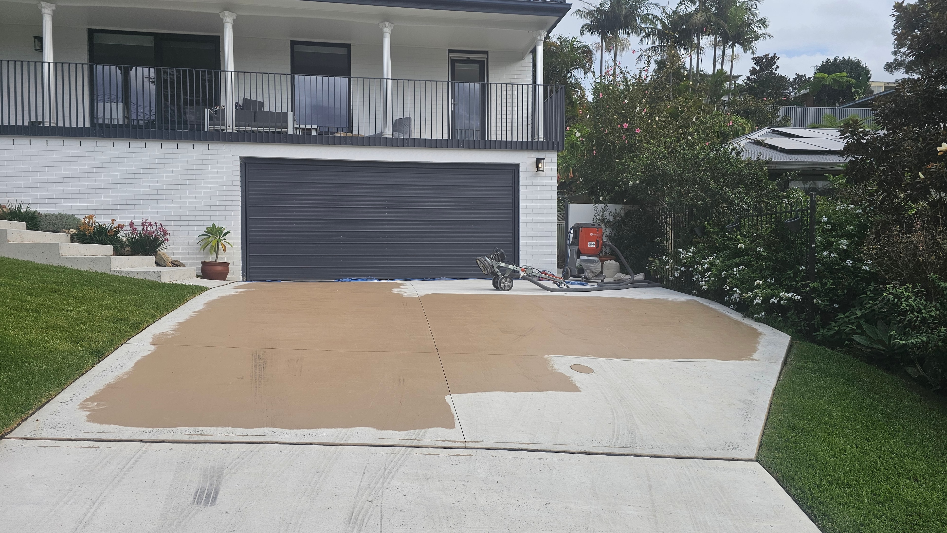 Residential driveway during concrete grinding preparation