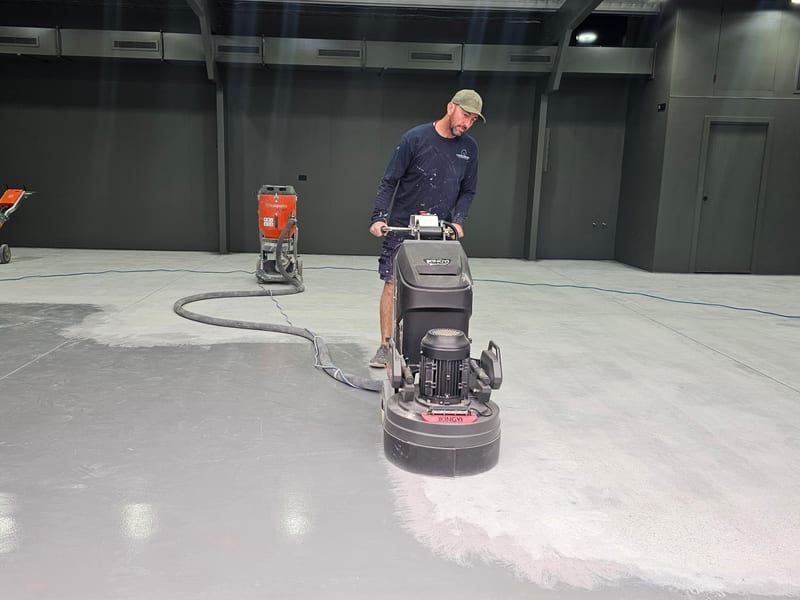 Worker operating concrete grinding machine